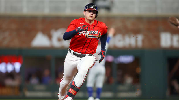 Sep 28, 2023; Atlanta, Georgia, USA; Atlanta Braves third baseman Austin Riley (27) hits a triple against the Chicago Cubs in the third inning at Truist Park.